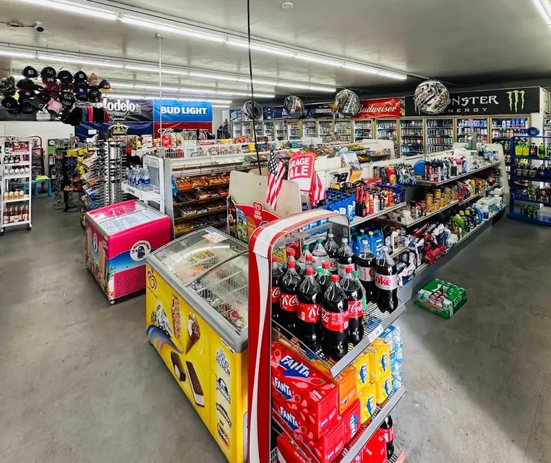 Wide interior view of Midland Food Center with snack aisles, freezers and refrigerated drinks