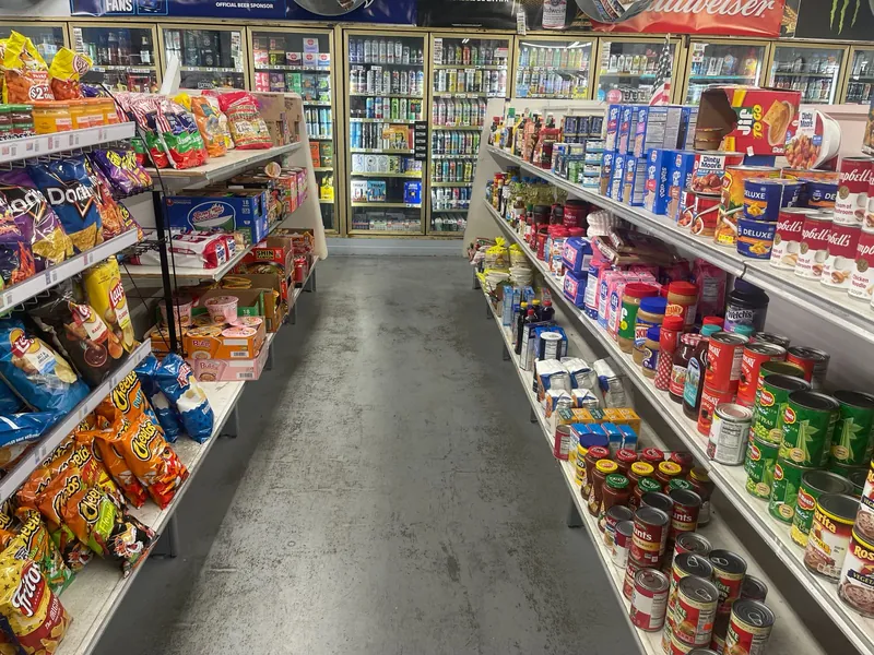 Aisles of chips, Korean ramen, pantry groceries and refrigerated beverages inside Midland Food Center